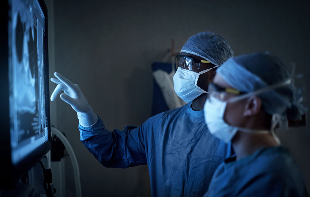 Två läkare som kollar på en patients röntgen